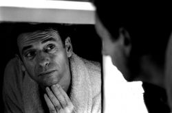 Yves Montand looking in a mirror